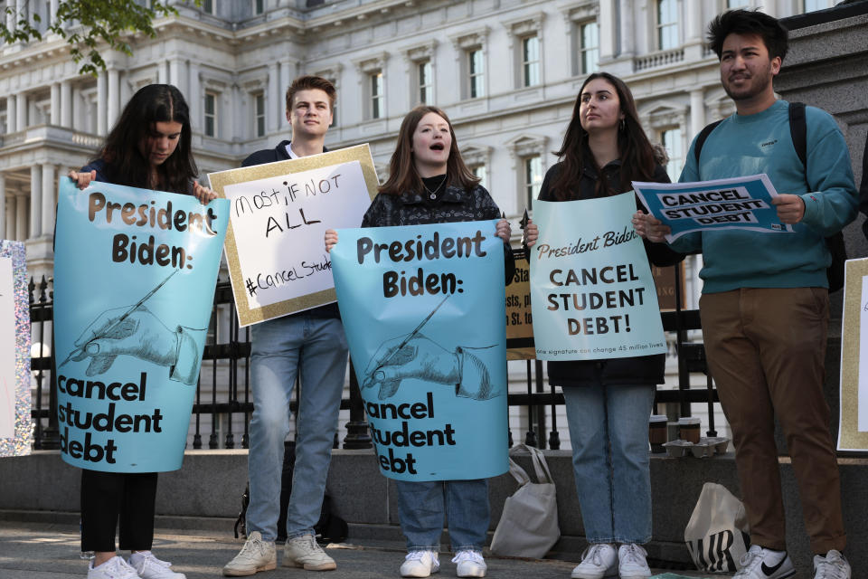 WASHINGTON, DC - APRIL 27: Activists hold signs as they attend a Student Loan Forgiveness rally on Pennsylvania Avenue and 17th street near the White House on April 27, 2022 in Washington, DC. Student loan activists including college students held the rally to celebrate U.S. President Joe Biden's extension of the pause on student loans and also urge him to sign an executive order that would fully cancel all student debt. (Photo by Anna Moneymaker/Getty Images)