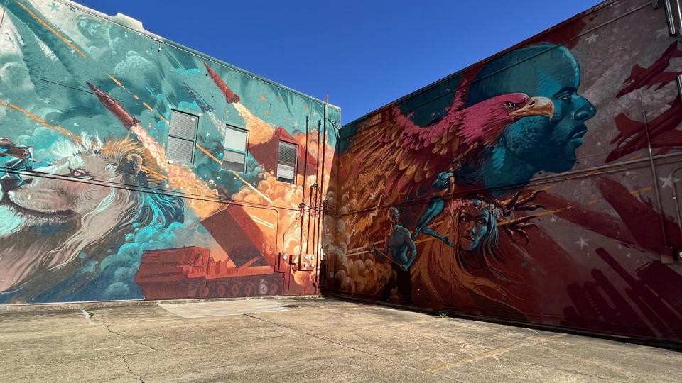 A resident in downtown Camden, Ark., commissioned artist Kiptoe to paint this mural on the side of his apartment building to promote the growing vibrancy of the small city. Prominently featured in the work are M270 launchers, which Lockheed Martin has made at its Camden facility since 1980. (Jen Judson/Staff)