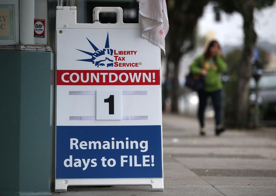 A sign advertising one day remaining before the tax filing deadline is posted in front of  Liberty Tax Service.