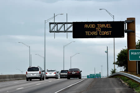 A sign along I-35E warns against travel southeast Texas after Hurricane Harvey made landfall on the Texas Gulf coast, in Dallas, Texas, U.S. August 26, 2017. Picture taken through windshield. REUTERS/Nick Oxford