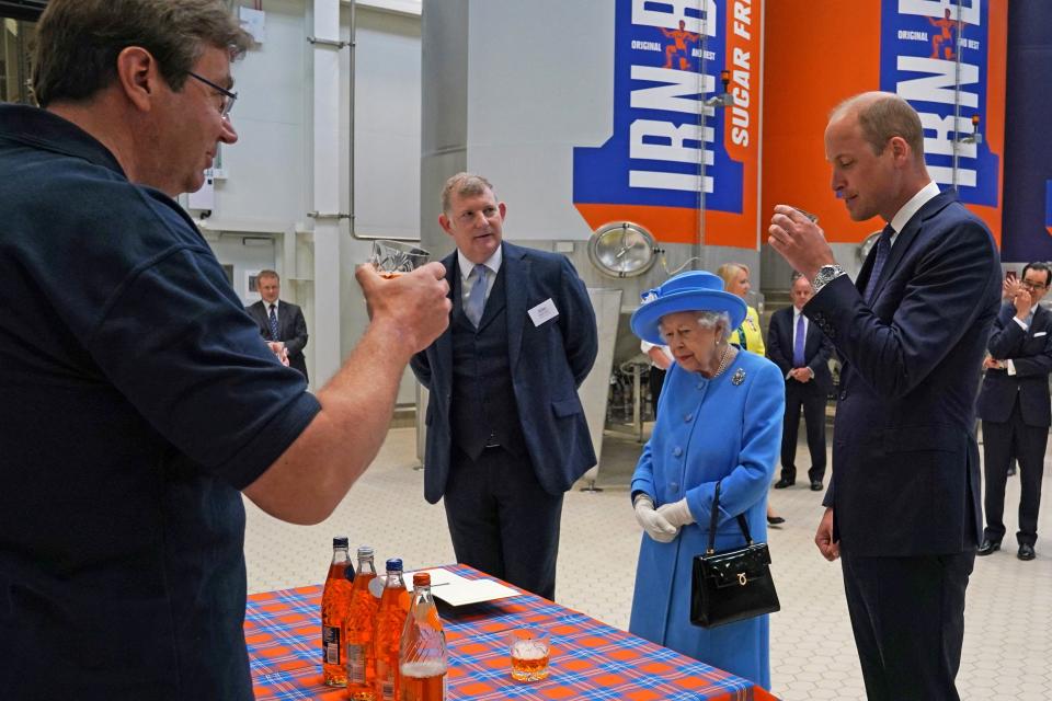 Britain's Prince William, Duke of Cambridge (R) samples Irn-Bru as he and Britain's Queen Elizabeth II  visit AG Barr's factory in Cumbernauld, east of Glasgow, where the Irn-Bru drink is manufactured on June 28, 2021. - The Queen is in Scotland for Royal Week where she will be undertaking a range of engagements celebrating community, innovation and history. (Photo by Andrew Milligan / POOL / AFP) (Photo by ANDREW MILLIGAN/POOL/AFP via Getty Images)