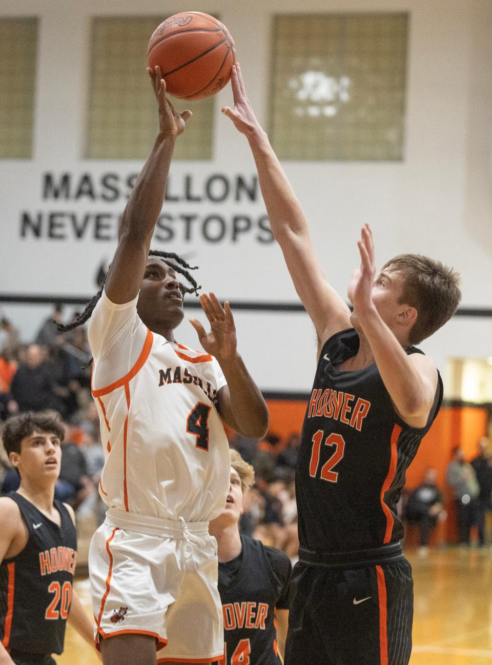 Massillon's Terrelle Keyes shoots in the first half as Hoover's Hudson Pringle defends.
