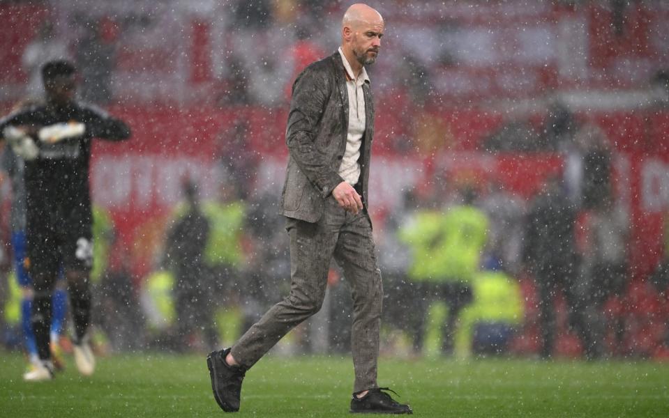 Erik ten Hag, Manager of Manchester United, leaves the field in the rain following defeat to Arsenal during the Premier League match between Manchester United and Arsenal FC at Old Trafford on May 1