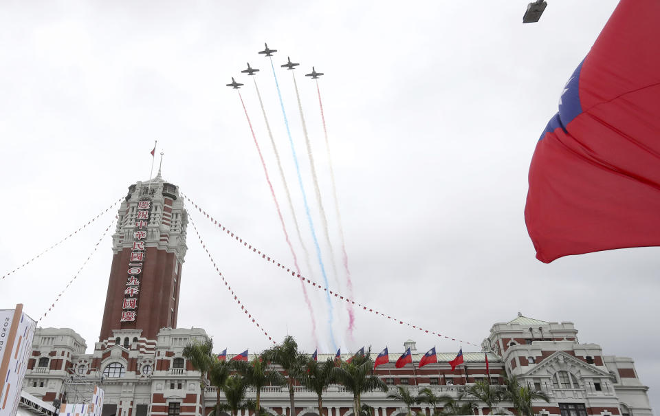 Thunder Tiger Aerobatics Team fly over President Office during the National Day celebrations in Taipei, Taiwan, Saturday, Oct. 10, 2020. Taiwanese President Tsai Ing-wen said Saturday she has hopes for less tensions with China and in the region if Beijing will listen to Taipei’s concerns, alter its approach and restart dialogue with the self-ruled island democracy. (AP Photo/Chiang Ying-ying)