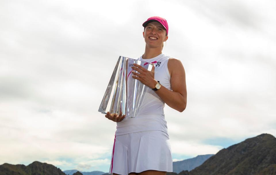 2024 BNP Paribas Open Champion Iga Swiatek poses for a photo with her trophy from a viewpoint in Stadium 1 in Indian Wells, Calif., Sunday, March 17, 2024.