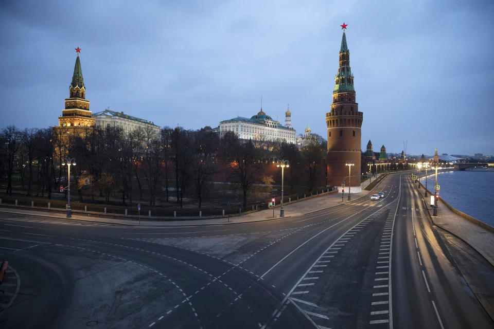 A view of the unusually empty embankment during evening rush hour outside the Kremlin in Moscow, Russia, Wednesday, April 1, 2020. The Russian capital has woken up to a lockdown obliging most people in the city of 13 million to stay home. The government ordered other regions of the vast country to quickly prepare for the same as Moscow, to stem the spread of the new coronavirus. The new coronavirus causes mild or moderate symptoms for most people, but for some, especially older adults and people with existing health problems, it can cause more severe illness or death. (AP Photo/Pavel Golovkin)