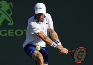 Mar 28, 2017; Miami, FL, USA; Roberto Bautista Agut of Spain hits a backhand against Roger Federer of Switzerland (not pictured) on day eight of the 2017 Miami Open at Crandon Park Tennis Center. Mandatory Credit: Geoff Burke-USA TODAY Sports