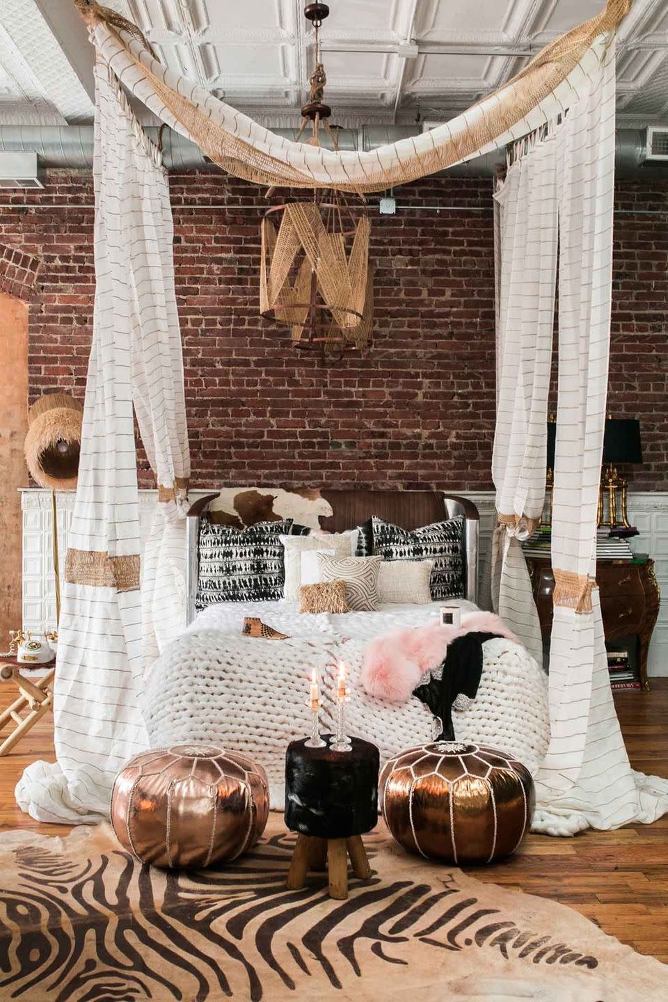 a room with a brick wall and a white ceiling with a white and black bird on it