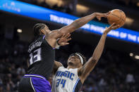 Sacramento Kings center Tristan Thompson (13) blocks the shot of Orlando Magic center Wendell Carter Jr. (34) during the second half of an NBA basketball game in Sacramento, Calif., Wednesday, Dec. 8, 2021. (AP Photo/Jose Luis villegas)