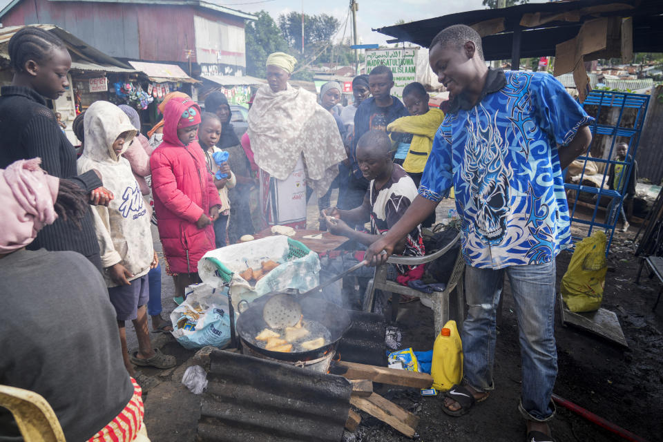 *HOLD moving tomorrow 0400* FILE - A man uses cooking oil to fry Mandazi, a type of fried bread, on a street in the low-income Kibera neighborhood of Nairobi, Kenya, Wednesday, April 20, 2022. (AP Photo/Khalil Senosi)