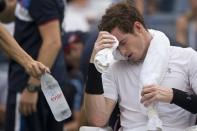 Andy Murray of Britain is offered water during a break in play in his second round match against Adrian Mannarino of France at the U.S. Open Championships tennis tournament in New York, September 3, 2015. REUTERS/Carlo Allegri