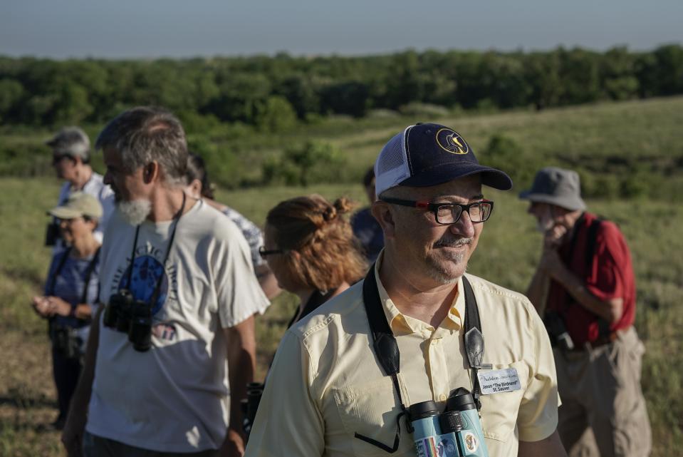 Jason St. Sauver, center, senior manager for education at Spring Creek Prairie Audubon Center, leads a grassland birds tour, Tuesday, June 20, 2023, in Denton, Neb. North America's grassland birds are deeply in trouble 50 years after adoption of the Endangered Species Act, with numbers plunging as habitat loss, land degradation and climate change threaten what remains of a once-vast ecosystem. (AP Photo/Joshua A. Bickel)