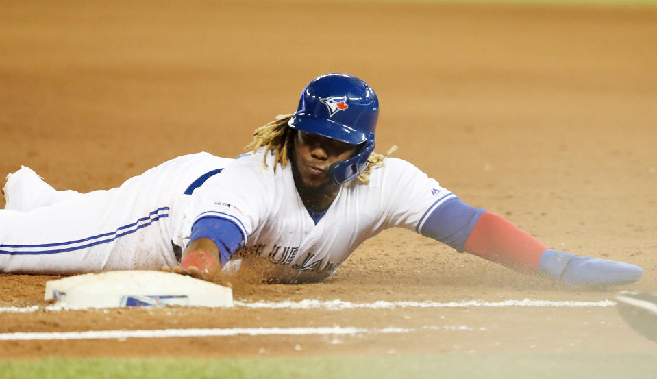 TORONTO, ON- MAY 22  - Toronto Blue Jays third baseman Vladimir Guerrero Jr. (27) slides back into first base  as the Toronto Blue Jays play the Boston Red Sox  at  Rogers Centre in Toronto. May 22, 2019.        (Steve Russell/Toronto Star via Getty Images)