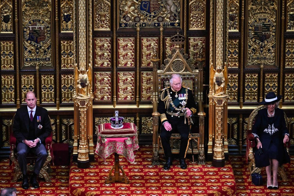 Prince Charles, Prince of Wales (2nd R) sits by the The Imperial State Crown (2nd L) with Britain's Prince William, Duke of Cambridge (L) and Britain's Camilla, Duchess of Cornwall (R) in the House of Lords Chamber, during the State Opening of Parliament
