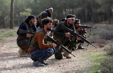 Turkish-backed Free Syrian Army fighters take up position as they advance north of Afrin, March 6. REUTERS/Khalil Ashawi