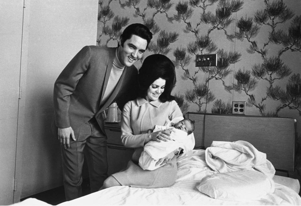 FILE - Lisa Marie Presley poses for her first picture in the lap of her mother, Priscilla, on Feb. 5, 1968, with her father, Elvis Presley, in Memphis, Tenn. On Thursday, Jan. 26, 2023, Priscilla Presley filed legal documents disputing who oversees the estate of her late daughter Lisa Marie Presley. A singer and the only child of Elvis Presley, died at a hospital at age 54 on Jan. 12. (AP Photo/Perry Aycock, File)