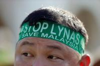 FILE PHOTO: FILE PHOTO: An activist wears a headband during a protest against Australia's Lynas Corp rare earths plant during a rally in Kuala Lumpur, Malaysia