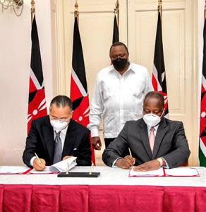 H.E. President Uhuru Kenyatta overlooking Kenya's Health Minister Mutahi Kagwe signing MoU with GKSD President Kamel Ghribi