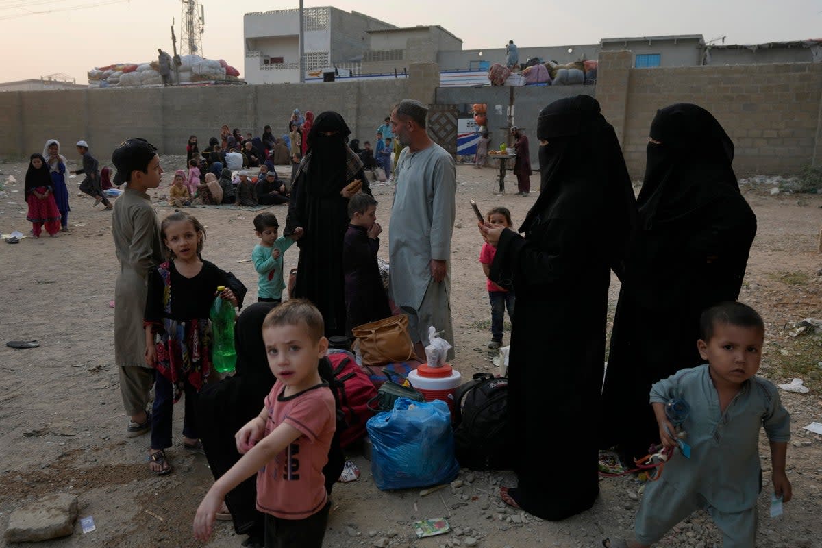 Afghan families wait in Karachi, Pakistan for transport to take them to their homeland (Associated Press)