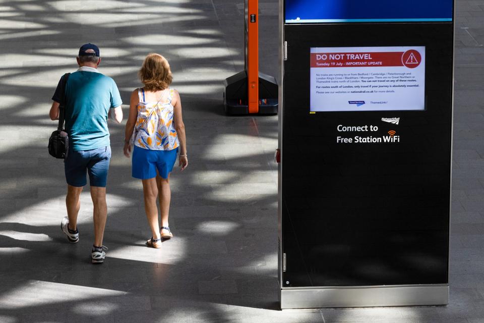 A screen displaying train cancellation information during a heat wave at London King's Cross railway station in London, U.K.,