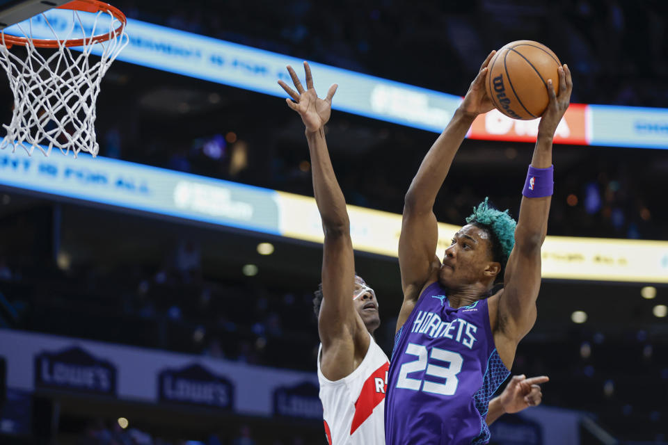 Charlotte Hornets forward Kai Jones (23) drives for a dunk against Toronto Raptors center Christian Koloko during the first half of an NBA basketball game in Charlotte, N.C., Sunday, April 2, 2023. (AP Photo/Nell Redmond)