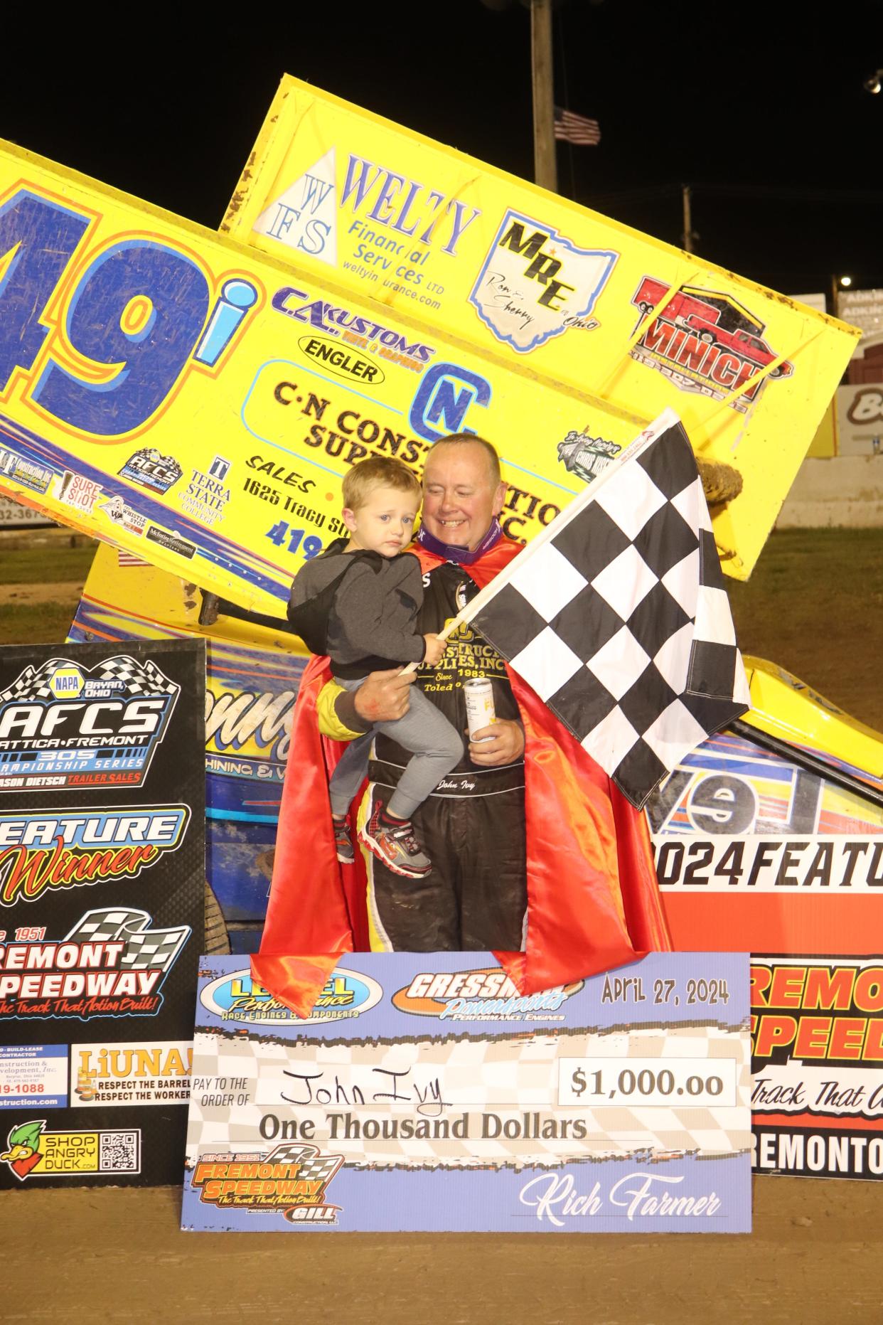 John Ivy celebrates in Victory Lane with his grandson Grayson Steyer on Super Heroes Night at Fremont Speedway.