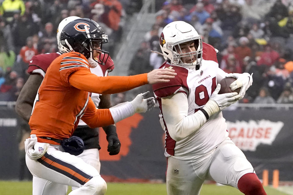 Arizona Cardinals defensive end Zach Allen advances the ball after intercepting a pass by Chicago Bears quarterback Andy Dalton ,left, during the second half of an NFL football game Sunday, Dec. 5, 2021, in Chicago. The Cardinals won 33-22. (AP Photo/David Banks)