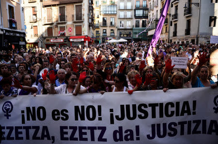 People protest the provisional release granted to five men cleared of the gang rape of a teenager and convicted of a lesser crime of sexual abuse, behind a banner reading "No is No. Justice", in Pamplona, Spain, June 22, 2018. REUTERS/Vincent West