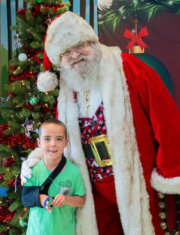 <p>T.J. Hamilton/Make-A-Wish Michigan</p> Santa Claus and Wish alumnus Caden Anderson at a Christmas in July event