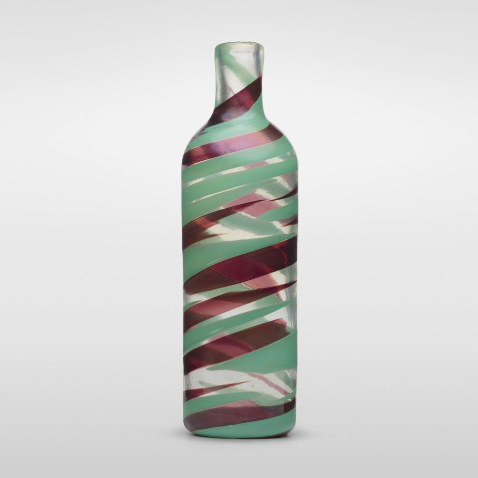 a clear and aqua and magenta glass striped bottle