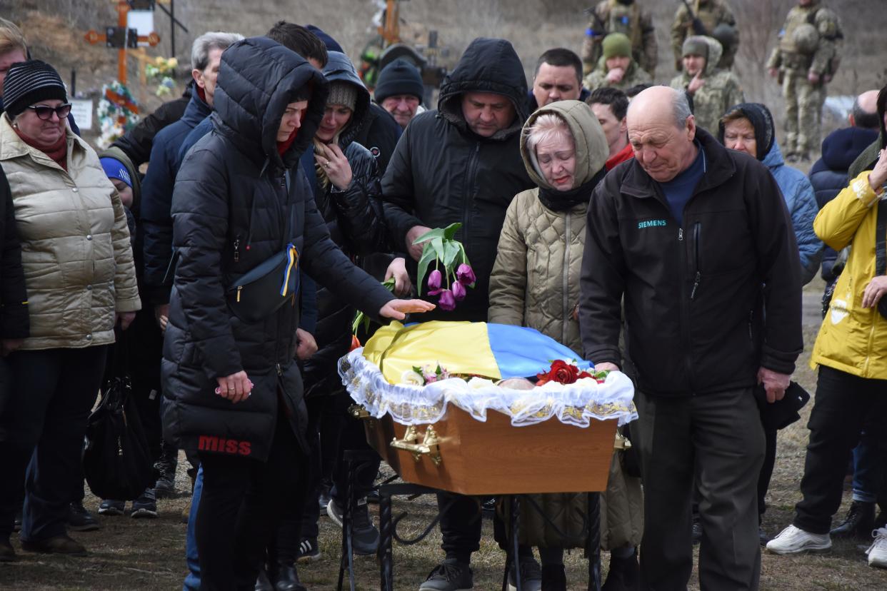 Relatives and friends react near the coffin of Ukrainian servicemen Oleksiy Lunyov in Yuzhne, Odessa region, Ukraine, Sunday.