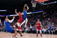 Feb 1, 2019; Denver, CO, USA; Denver Nuggets guard Malik Beasley (25) drives to the net against Houston Rockets guard Eric Gordon (10) as guard Austin Rivers (25) and forward Trey Lyles (7) defend in the second quarter at the Pepsi Center. Mandatory Credit: Isaiah J. Downing-USA TODAY Sports