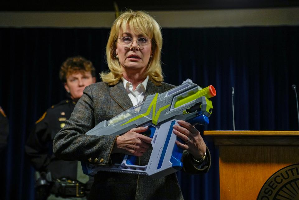 Melissa Powers, Hamilton County prosecutor shows the Nerf gun a 16-year-old was using when he was shot on March 6 in Anderson Township. Powers announced on Thursday, March 16, 2023  that Bengals Joe Mixon's sister, Shalonda Mixon and her boyfriend, Lamonte Brewer have been indicted in connection to the shooting. Powers said multiple juveniles were playing dart wars and that Brewer and others should have been able to tell that the juveniles were carrying toy weapons.