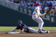 Mississippi's Kevin Graham (35) steals second base against Oklahoma second baseman Jackson Nicklaus, right, in the first inning during the first championship baseball game of the NCAA College World Series Saturday, June 25, 2022, in Omaha, Neb. (AP Photo/John Peterson)