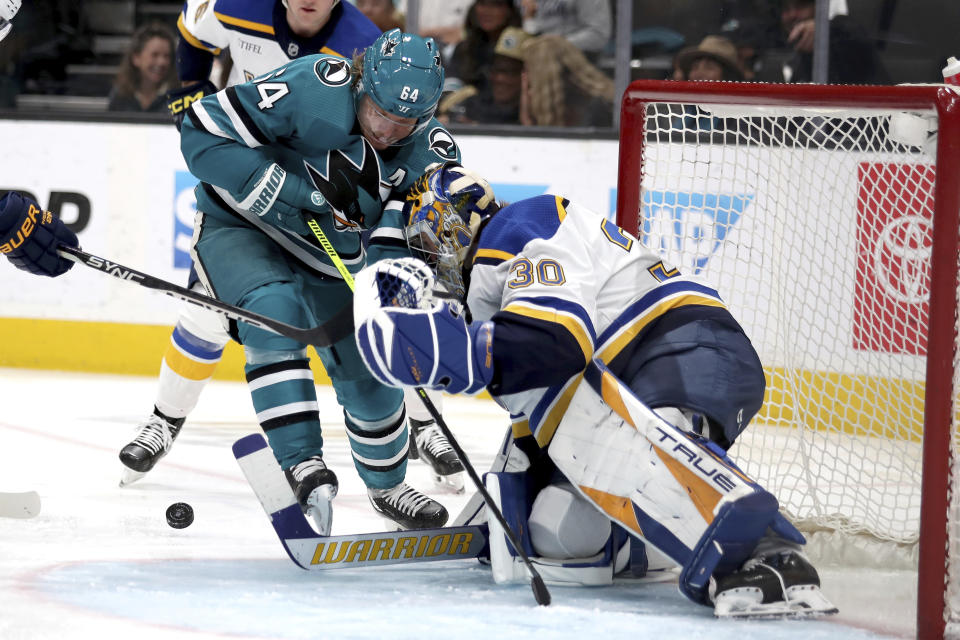 St. Louis Blues goaltender Joel Hofer (30) blocks a shot on goal by San Jose Sharks center Mikael Granlund (64) in the first period of an NHL hockey game in San Jose, Calif., Saturday, April 6, 2024. (AP Photo/Scot Tucker)