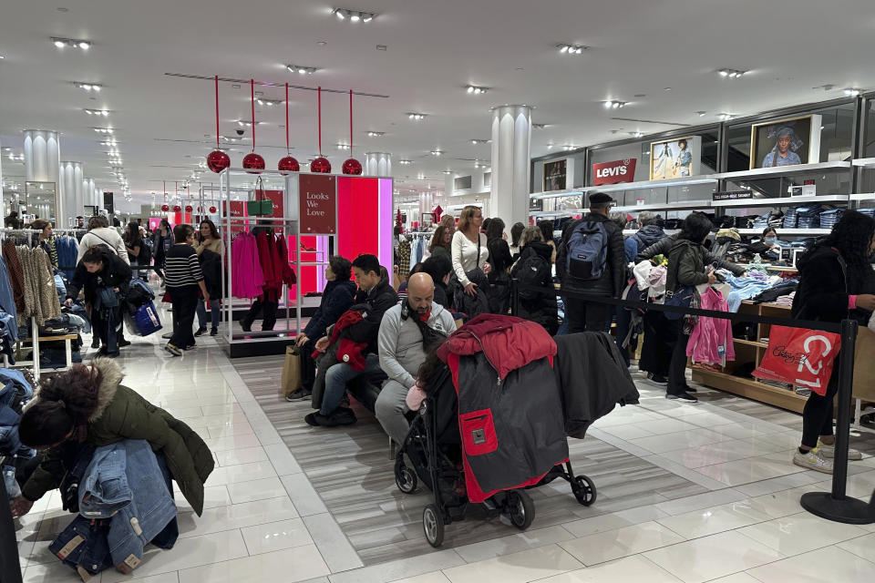 Black Friday shoppers look through merchandise at Macy's in Herald Square on Friday, Nov. 24, 2023, in New York. (AP Photo/Anne D'Innocenzio)
