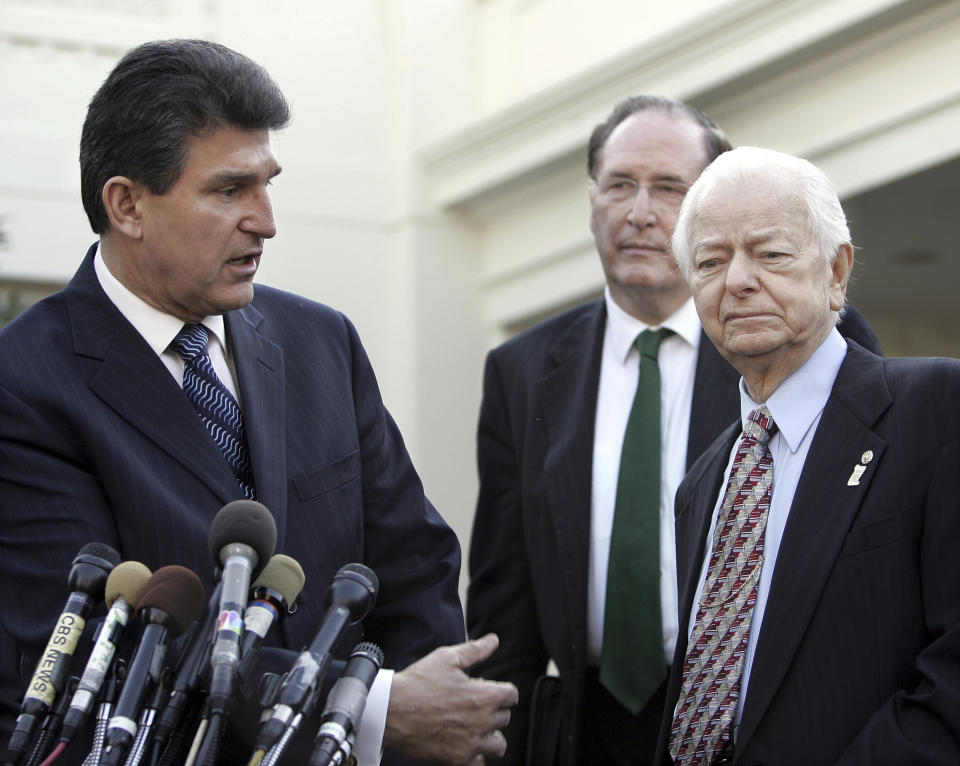 FILE - West Virginia Gov. Joe Manchin, left, speaks to members of the media, Tuesday, Jan. 24, 2006, along with Sen. John Rockefeller, D-W.Va., center, and Sen. Robert Byrd, D-W.Va., after their meeting with White House officials at the White House. Manchin announced Thursday, Nov. 9, 2023, that he is not seeking reelection to the U.S. Senate in 2024. (AP Photo/Ron Edmonds, File)