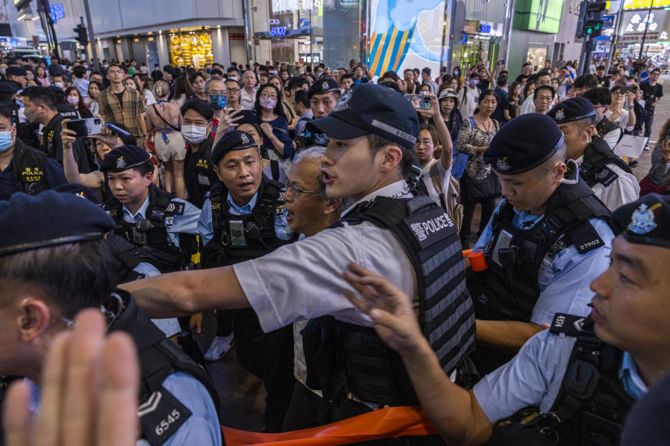 A member of the public is taken away by the police in the Causeway Bay area on the eve 34th anniversary of China's Tiananmen Square massacre in Hong Kong, Saturday, June 3, 2023. (AP Photo/Louise Delmotte)