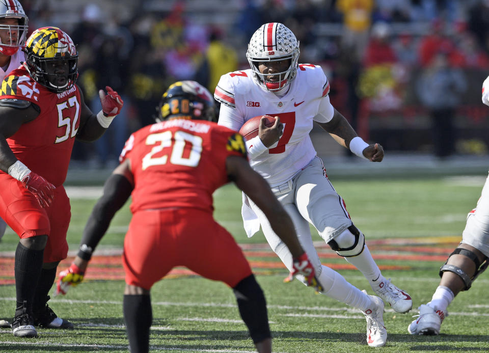 FILE - In this Saturday, Nov. 17, 2018, file photo, Ohio State quarterback Dwayne Haskins Jr. (7) runs with the ball against Maryland defensive back Antwaine Richardson (20) and defensive lineman Oluwaseun Oluwatimi (52) during the first half of an NCAA football game in College Park, Md. Ohio Stat coach Urban Meyer, says Haskins wasn’t a fully legitimate leader until he showed he was willing to run the ball two weeks ago in the narrow overtime win over Maryland.(AP Photo/Nick Wass, File)