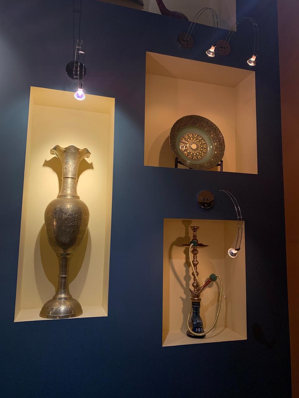 Niches at Laziza display Lebanese collectibles including a hookah.