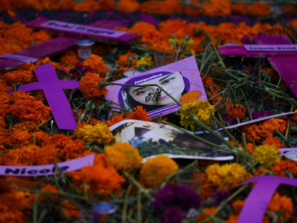 A photo of woman victim of gender violence is placed on an altar during Day of the Dead celebrations in Mexico City, Monday, Nov. 1, 2021.