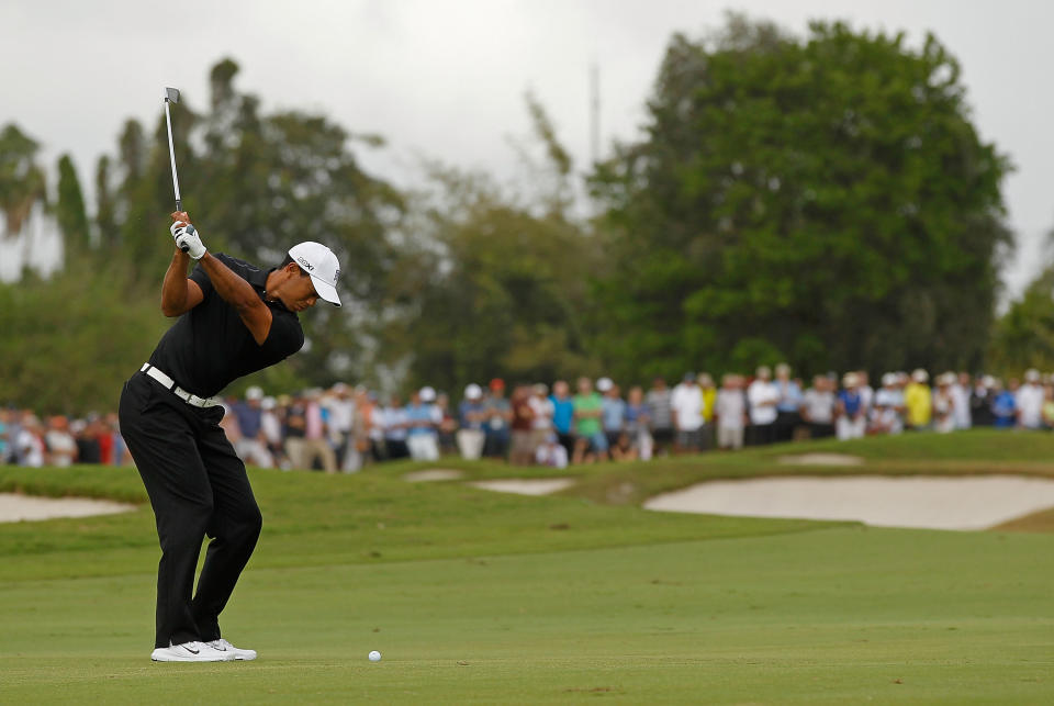 MIAMI, FL - MARCH 08: Tiger Woods hits his approach shot on the fifth hole during the first round of the 2012 World Golf Championships Cadillac Championship at Doral Golf Resort And Spa on March 8, 2012 in Miami, Florida. (Photo by Mike Ehrmann/Getty Images)