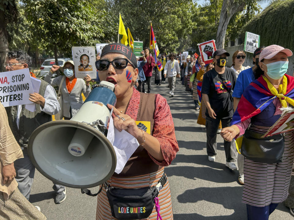 Exile Tibetans shout slogans to mark the anniversary of the 1959 Tibetan uprising in Lhasa, in New Delhi, India, Sunday, March 10, 2024. Hundreds of Tibetans in exile marched on the New Delhi streets on Sunday to commemorate the 65th Tibetan National Uprising Day against China to honor the Tibetan martyrs and express concern over the appalling situation in Tibet. (AP Photo/Shonal Ganguly)