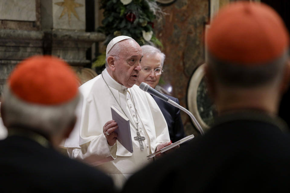 Pope Francis holds two books he presented as a gift to cardinals and bishops on the occasion of his Christmas greetings to the Roman Curia, in the Clementine Hall at the Vatican, Saturday, Dec. 21, 2019. (AP Photo/Andrew Medichini, Pool)