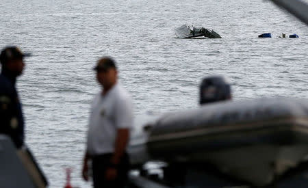 Rescue workers are seen near a plane, which crashed with Brazilian Supreme Court Justice Teori Zavascki, who was overseeing a graft investigation into scores of powerful politicians, in Paraty, Rio de Janeiro state, Brazil, January 20, 2017. REUTERS/Bruno Kelly