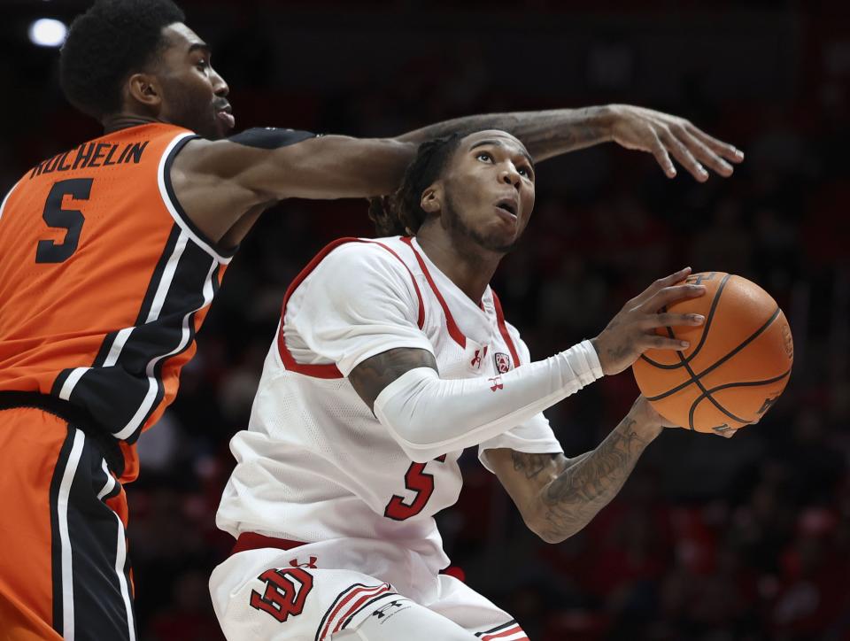 Oregon State Beavers guard Justin Rochelin (5) tries to block Utah Utes guard Deivon Smith (5) at the University of Utah’s Huntsman Center in Salt Lake City on Thursday, Jan. 18, 2024. | Laura Seitz, Deseret News