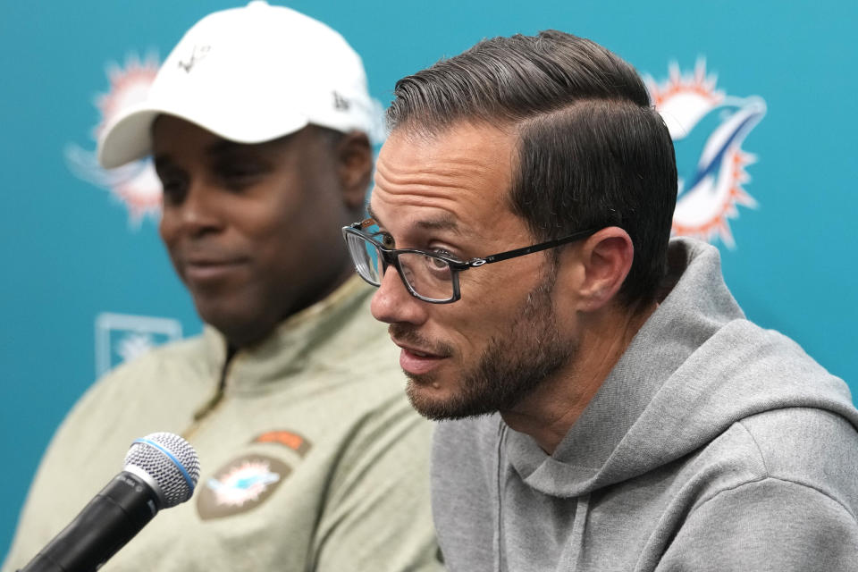 Miami Dolphins general manager Chris Grier, left, listens as head coach Mike McDaniel responds to a question during a news conference at the NFL football team's training facility, Monday, Jan. 16, 2023, in Miami Gardens, Fla. (AP Photo/Lynne Sladky)