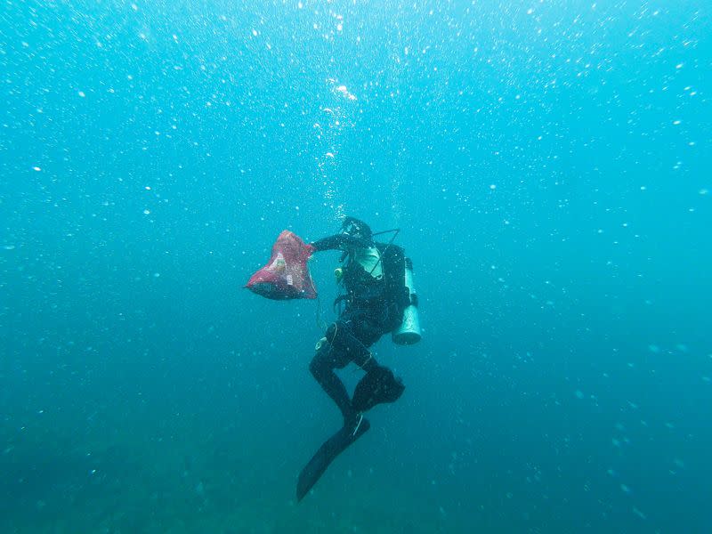 Divers participate in an underwater cleanup drive on World Cleanup Day in Philippines