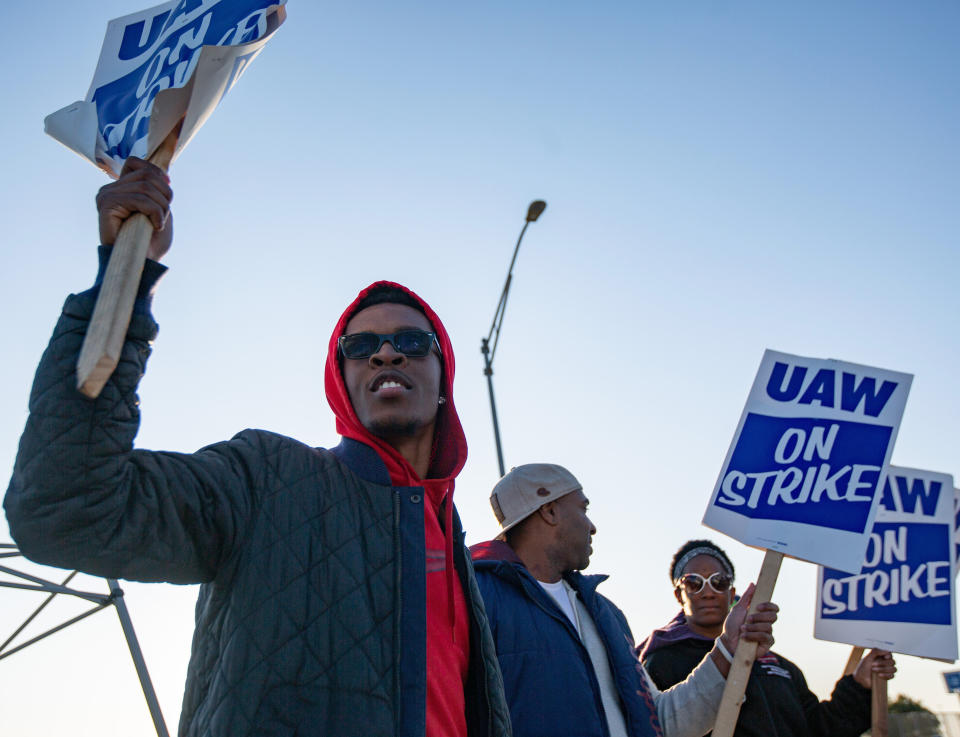 Motorline worker Ray Gladney of Florrisant, materials worker Brookes Robinson of Central West End, and Trim Doorline Worker Danielle Harris of Richmond Heights, picket at the General Motors plant in Wentzville, Mo., on Tuesday, Oct. 22, 2019. United Auto Workers around the country will be voting on whether to accept or deny the recent offer made to the union by GM in the coming week. (Troy Stolt/St. Louis Post-Dispatch via AP)