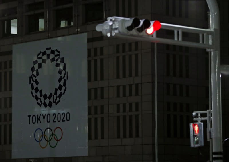 Banner for the upcoming Tokyo 2020 Olympics is seen behind traffic lights in Tokyo